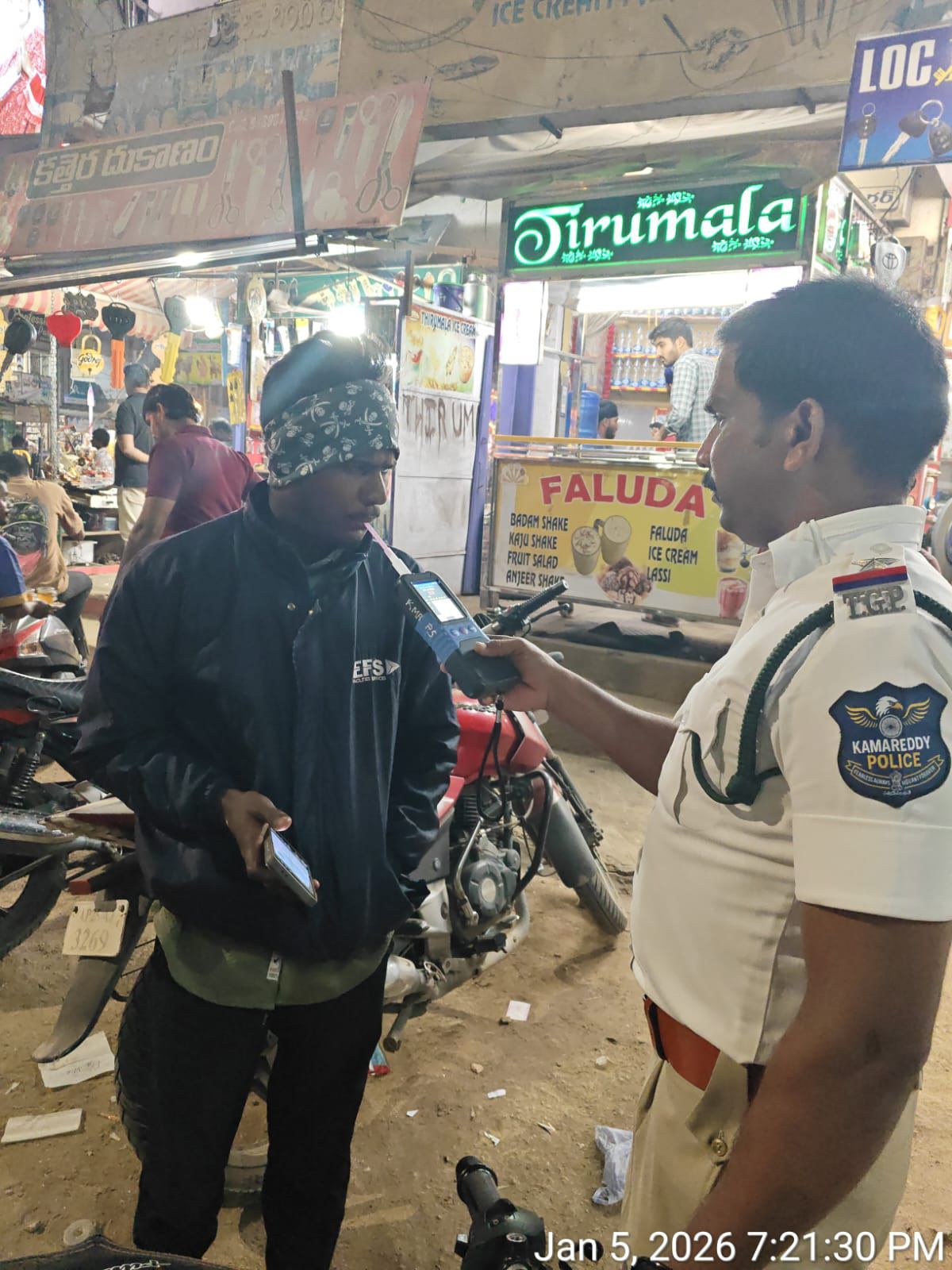 Police officer using breath analyzer during traffic check